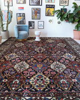 Antique Persian area rug in a living room setting, pile rug, vintage rug, portland, rug shop, bright colors, wild shaman, soft rug, bold color, Portland, Oregon, rug store, rug shop, local shop, antique rug, Persian rug, handmade rug, wool rug, distressed rug