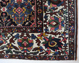 Antique Persian area rug in a living room setting, pile rug, vintage rug, portland, rug shop, bright colors, wild shaman, soft rug, bold color, Portland, Oregon, rug store, rug shop, local shop, antique rug, Persian rug, handmade rug, wool rug, distressed rug