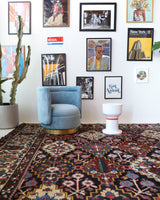 Antique Persian area rug in a living room setting, pile rug, vintage rug, portland, rug shop, bright colors, wild shaman, soft rug, bold color, Portland, Oregon, rug store, rug shop, local shop, antique rug, Persian rug, handmade rug, wool rug, distressed rug