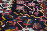 Antique Persian area rug in a living room setting, pile rug, vintage rug, portland, rug shop, bright colors, wild shaman, soft rug, bold color, Portland, Oregon, rug store, rug shop, local shop, antique rug, Persian rug, handmade rug, wool rug, distressed rug