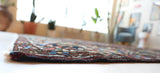 Antique Persian area rug in a living room setting, pile rug, vintage rug, portland, rug shop, bright colors, wild shaman, soft rug, bold color, Portland, Oregon, rug store, rug shop, local shop, antique rug, Persian rug, handmade rug, wool rug, distressed rug