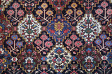 Antique Persian area rug in a living room setting, pile rug, vintage rug, portland, rug shop, bright colors, wild shaman, soft rug, bold color, Portland, Oregon, rug store, rug shop, local shop, antique rug, Persian rug, handmade rug, wool rug, distressed rug