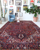 Antique Persian area rug in a living room setting, pile rug, vintage rug, portland, rug shop, bright colors, wild shaman, soft rug, bold color, Portland, Oregon, rug store, rug shop, local shop, antique rug, Persian rug, handmade rug, wool rug