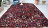 Antique Persian area rug in a living room setting, pile rug, vintage rug, portland, rug shop, bright colors, wild shaman, soft rug, bold color, Portland, Oregon, rug store, rug shop, local shop, antique rug, Persian rug, handmade rug, wool rug