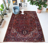 Antique Persian area rug in a living room setting, pile rug, vintage rug, portland, rug shop, bright colors, wild shaman, soft rug, bold color, Portland, Oregon, rug store, rug shop, local shop, antique rug, Persian rug, handmade rug, wool rug