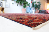 Antique Turkmen rug in a living room setting, pile rug, Turkish rug, vintage rug, portland, rug shop, bright colors, wild shaman, soft rug, bold color, Portland, Oregon, rug store, rug shop, local shop, antique rug
