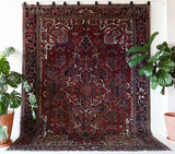 Antique Persian area rug in a living room setting, pile rug, vintage rug, portland, rug shop, bright colors, wild shaman, soft rug, bold color, Portland, Oregon, rug store, rug shop, local shop, antique rug, Persian rug, handmade rug, wool rug, distressed rug