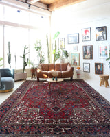 Antique Persian area rug in a living room setting, pile rug, vintage rug, portland, rug shop, bright colors, wild shaman, soft rug, bold color, Portland, Oregon, rug store, rug shop, local shop, antique rug, Persian rug, handmade rug, wool rug, distressed rug