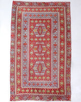 Vintage kilim rug in living room setting, old rug, antique rug, pastel colors, faded colors, Turkish rug, vintage rug, soft rug, Portland, Oregon, rug store, rug shop, local shop, earthy tones, earthy colors, warm colors