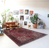 Antique Persian area rug in a living room setting, pile rug, vintage rug, portland, rug shop, bright colors, wild shaman, soft rug, bold color, Portland, Oregon, rug store, rug shop, local shop, antique rug, Persian rug, handmade rug, wool rug, distressed rug