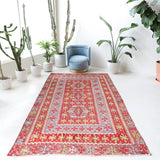 Vintage kilim rug in living room setting, old rug, antique rug, pastel colors, faded colors, Turkish rug, vintage rug, soft rug, Portland, Oregon, rug store, rug shop, local shop, earthy tones, earthy colors, warm colors