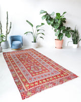 Vintage kilim rug in living room setting, old rug, antique rug, pastel colors, faded colors, Turkish rug, vintage rug, soft rug, Portland, Oregon, rug store, rug shop, local shop, earthy tones, earthy colors, warm colors