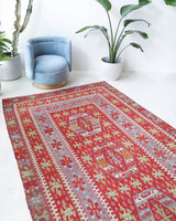 Vintage kilim rug in living room setting, old rug, antique rug, pastel colors, faded colors, Turkish rug, vintage rug, soft rug, Portland, Oregon, rug store, rug shop, local shop, earthy tones, earthy colors, warm colors