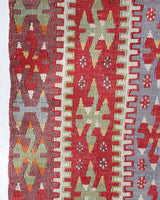 Vintage kilim rug in living room setting, old rug, antique rug, pastel colors, faded colors, Turkish rug, vintage rug, soft rug, Portland, Oregon, rug store, rug shop, local shop, earthy tones, earthy colors, warm colors