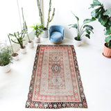 Vintage kilim rug in living room setting, old rug, antique rug, pastel colors, faded colors, Turkish rug, vintage rug, soft rug, Portland, Oregon, rug store, rug shop, local shop, earthy tones, earthy colors, warm colors