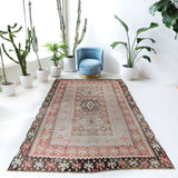 Vintage kilim rug in living room setting, old rug, antique rug, pastel colors, faded colors, Turkish rug, vintage rug, soft rug, Portland, Oregon, rug store, rug shop, local shop, earthy tones, earthy colors, warm colors