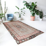 Vintage kilim rug in living room setting, old rug, antique rug, pastel colors, faded colors, Turkish rug, vintage rug, soft rug, Portland, Oregon, rug store, rug shop, local shop, earthy tones, earthy colors, warm colors