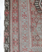 Vintage kilim rug in living room setting, old rug, antique rug, pastel colors, faded colors, Turkish rug, vintage rug, soft rug, Portland, Oregon, rug store, rug shop, local shop, earthy tones, earthy colors, warm colors