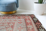Vintage kilim rug in living room setting, old rug, antique rug, pastel colors, faded colors, Turkish rug, vintage rug, soft rug, Portland, Oregon, rug store, rug shop, local shop, earthy tones, earthy colors, warm colors