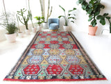 Vintage kilim rug in living room setting, bright colors, wild shaman, soft rug, bold color, Portland, Oregon, rug store, rug shop, local shop, vintage rug, modern kilim, warm colors, antique kilim rug
