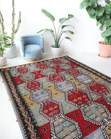 Vintage kilim rug in living room setting, bright colors, wild shaman, soft rug, bold color, Portland, Oregon, rug store, rug shop, local shop, vintage rug, modern kilim, warm colors, antique kilim rug