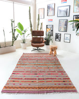 Vintage kilim rug in living room setting, old rug, antique rug, pastel colors, faded colors, Turkish rug, vintage rug, soft rug, Portland, Oregon, rug store, rug shop, local shop, earthy tones, earthy colors, warm colors