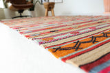 Vintage kilim rug in living room setting, old rug, antique rug, pastel colors, faded colors, Turkish rug, vintage rug, soft rug, Portland, Oregon, rug store, rug shop, local shop, earthy tones, earthy colors, warm colors