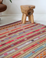 Vintage kilim rug in living room setting, old rug, antique rug, pastel colors, faded colors, Turkish rug, vintage rug, soft rug, Portland, Oregon, rug store, rug shop, local shop, earthy tones, earthy colors, warm colors