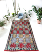 Vintage kilim rug in living room setting, bright colors, wild shaman, soft rug, bold color, Portland, Oregon, rug store, rug shop, local shop, vintage rug, modern kilim, warm colors, antique kilim rug