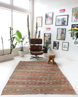 Vintage kilim rug in living room setting, old rug, antique rug, pastel colors, faded colors, Turkish rug, vintage rug, soft rug, Portland, Oregon, rug store, rug shop, local shop, earthy tones, earthy colors, warm colors