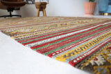 Vintage kilim rug in living room setting, old rug, antique rug, pastel colors, faded colors, Turkish rug, vintage rug, soft rug, Portland, Oregon, rug store, rug shop, local shop, earthy tones, earthy colors, warm colors