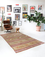 Vintage kilim rug in living room setting, old rug, antique rug, pastel colors, faded colors, Turkish rug, vintage rug, soft rug, Portland, Oregon, rug store, rug shop, local shop, earthy tones, earthy colors, warm colors