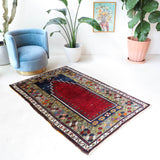 Vintage Turkish rug in a living room setting, pile rug, Turkish rug, vintage rug, portland, rug shop, bright colors, wild shaman, soft rug, bold color, Portland, Oregon, rug store, rug shop, local shop, antique rug