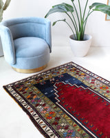 Vintage Turkish rug in a living room setting, pile rug, Turkish rug, vintage rug, portland, rug shop, bright colors, wild shaman, soft rug, bold color, Portland, Oregon, rug store, rug shop, local shop, antique rug