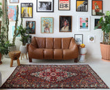 Antique Persian area rug in a living room setting, pile rug, vintage rug, portland, rug shop, bright colors, wild shaman, soft rug, bold color, Portland, Oregon, rug store, rug shop, local shop, antique rug, Persian rug, handmade rug, wool rug, distressed rug