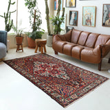 Antique Persian area rug in a living room setting, pile rug, vintage rug, portland, rug shop, bright colors, wild shaman, soft rug, bold color, Portland, Oregon, rug store, rug shop, local shop, antique rug, Persian rug, handmade rug, wool rug, distressed rug