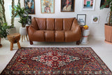 Antique Persian area rug in a living room setting, pile rug, vintage rug, portland, rug shop, bright colors, wild shaman, soft rug, bold color, Portland, Oregon, rug store, rug shop, local shop, antique rug, Persian rug, handmade rug, wool rug, distressed rug