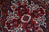 Antique Persian area rug in a living room setting, pile rug, vintage rug, portland, rug shop, bright colors, wild shaman, soft rug, bold color, Portland, Oregon, rug store, rug shop, local shop, antique rug, Persian rug, handmade rug, wool rug, distressed rug