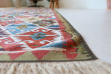 Vintage Turkish runner rug in a living room setting, pile rug, Turkish rug, vintage rug, portland, rug shop, bright colors, wild shaman, soft rug, bold color, Portland, Oregon, rug store, rug shop, local shop, antique rug