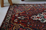 Antique Persian area rug in a living room setting, pile rug, vintage rug, portland, rug shop, bright colors, wild shaman, soft rug, bold color, Portland, Oregon, rug store, rug shop, local shop, antique rug, Persian rug, handmade rug, wool rug, distressed rug