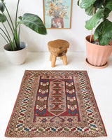 Vintage Turkish mini rug in room decor setting, old rug, antique rug, pastel colors, faded colors, Turkish rug, vintage rug, soft rug, Portland, Oregon, rug store, rug shop, local shop,  bright colors, bold colors