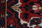 Antique Persian area rug in a living room setting, pile rug, vintage rug, portland, rug shop, bright colors, wild shaman, soft rug, bold color, Portland, Oregon, rug store, rug shop, local shop, antique rug, Persian rug, handmade rug, wool rug, distressed rug