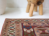 Vintage Turkish mini rug in room decor setting, old rug, antique rug, pastel colors, faded colors, Turkish rug, vintage rug, soft rug, Portland, Oregon, rug store, rug shop, local shop,  bright colors, bold colors