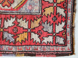 Small Turkish rug in a living room setting, pile rug, Turkish rug, vintage rug, portland, rug shop, bright colors, wild shaman, area rug, red rug, mini rug, bold color, Portland, Oregon, rug store, rug shop, local shop, flat weave, kilim rug