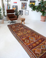 Vintage Turkish runner rug in a living room setting, pile rug, Turkish rug, vintage rug, portland, rug shop, bright colors, wild shaman, soft rug, bold color, Portland, Oregon, rug store, rug shop, local shop, antique rug