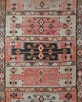 Vintage kilim rug in living room setting, old rug, antique rug, pastel colors, faded colors, Turkish rug, vintage rug, soft rug, Portland, Oregon, rug store, rug shop, local shop, earthy tones, earthy colors, warm colors