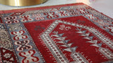 Small Turkish rug in a living room setting, pile rug, Turkish rug, vintage rug, portland, rug shop, bright colors, wild shaman, area rug, red rug, mini rug, bold color, Portland, Oregon, rug store, rug shop, local shop, flat weave, kilim rug