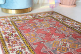 Small Turkish rug in a living room setting, pile rug, Turkish rug, vintage rug, portland, rug shop, bright colors, wild shaman, area rug, red rug, mini rug, bold color, Portland, Oregon, rug store, rug shop, local shop, flat weave, kilim rug