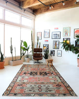 Vintage kilim rug in living room setting, old rug, antique rug, pastel colors, faded colors, Turkish rug, vintage rug, soft rug, Portland, Oregon, rug store, rug shop, local shop, earthy tones, earthy colors, warm colors