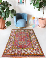 Small Turkish rug in a living room setting, pile rug, Turkish rug, vintage rug, portland, rug shop, bright colors, wild shaman, area rug, red rug, mini rug, bold color, Portland, Oregon, rug store, rug shop, local shop, flat weave, kilim rug